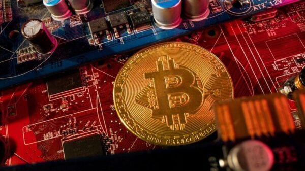 A representation of cryptocurrency Bitcoin is placed on a PC motherboard, in this illustration