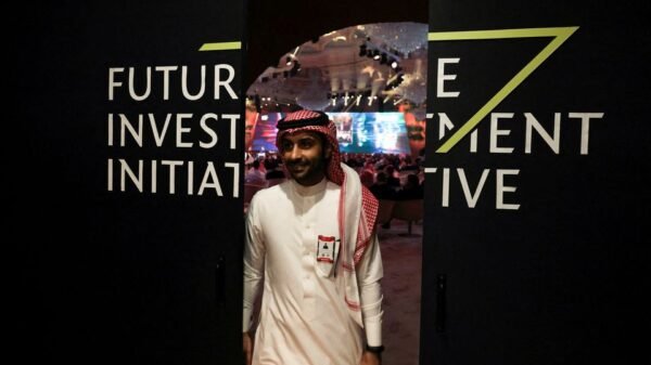 A Saudi man's reflection is seen in mirror glass at the Future Investment Initiative conference, in Riyadh, Saudi Arabia, October 25, 2022. REUTERS/ Ahmed Yosri/File Photo