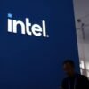 A man walks past the Intel logo at its booth during the first China International Supply Chain Expo (CISCE) in Beijing, China November 28, 2023. REUTERS/Florence Lo/File Photo