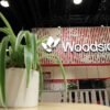 A plant decorates the booth of Australian petroleum exploration and production company Woodside Energy during the LNG 2023 energy trade show in Vancouver, British Columbia, Canada, July 13, 2023. REUTERS/Chris Helgren
